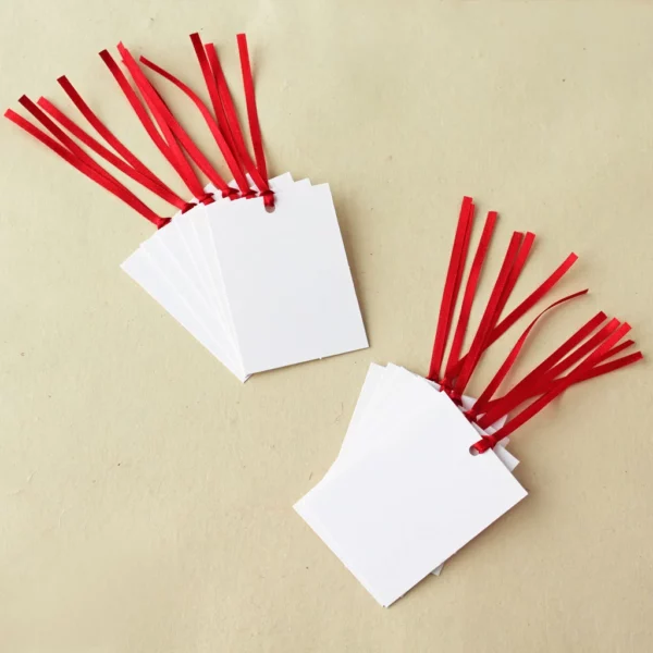 12 Plain white tags with red satin ribbons